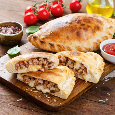 Sausage Calzones on wooden cutting board