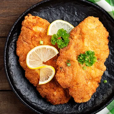 Pork Schnitzel on a black plate
