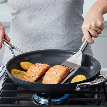 Pan seared salmon fillets in skillet